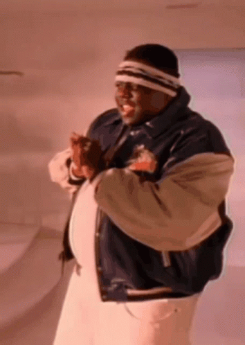 Man With Headband And Varsity Jacket Standing In Room GIF