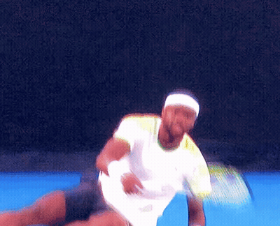 A Man Wearing A Headband And A White Shirt Is Playing Tennis GIF