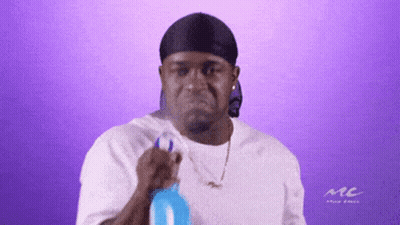 A Man Wearing A Headband And A White Shirt With The Word Mc On It GIF
