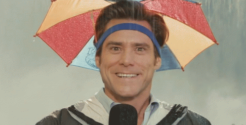 A Man Wearing A Headband And An Umbrella Is Smiling GIF