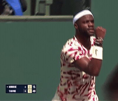 A Man Wearing A Headband And Nike Wristbands Holds His Fist Up In The Air GIF