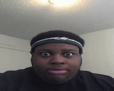 A Man Wearing A Headband Is Making A Funny Face While Looking At The Camera . GIF
