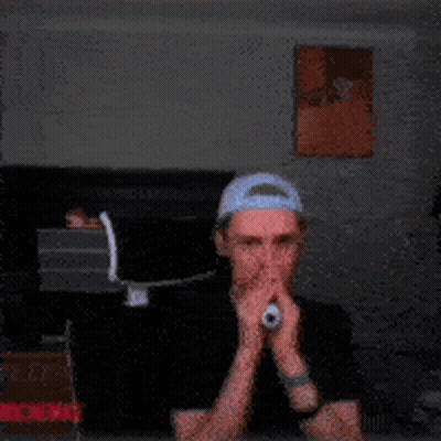 A Man Wearing A Headband Is Making A Funny Face With His Mouth Open GIF