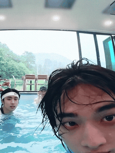A Man Wearing A Headband Is Swimming In A Pool With Other People GIF