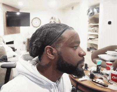 A Man Wearing A Headband Looks To The Side In A Room GIF