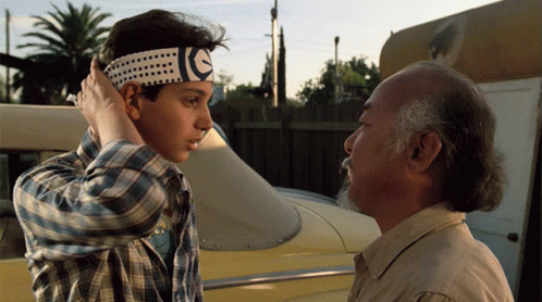 A Man Wearing A Headband With The Letter E On It GIF