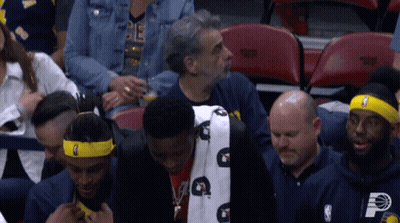 A Man Wearing A Headband With The Letter P On It Sits In The Stands GIF