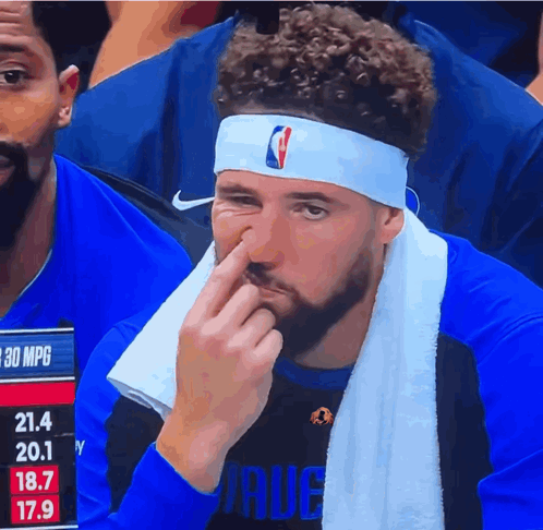 A Man Wearing A Headband With The Nba Logo On It Wipes His Nose GIF