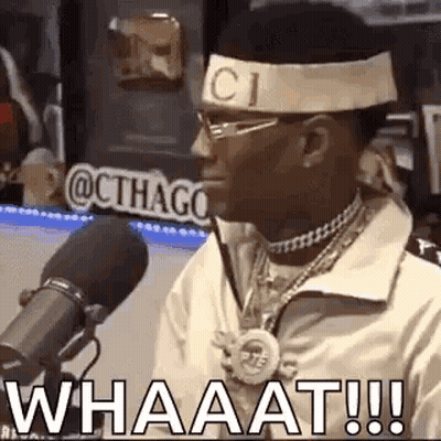 A Man Wearing A Headband With The Word Gucci On It Is Talking Into A Microphone . GIF