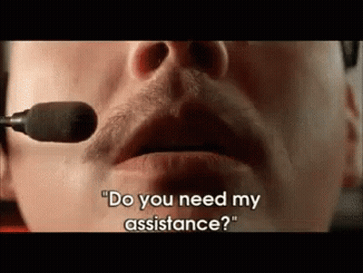 A Man Wearing A Headset Is Talking Into A Microphone And Asking If He Needs Assistance . GIF