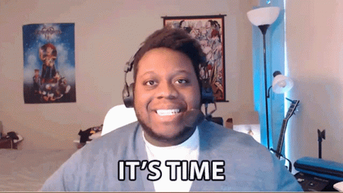 A Man Wearing A Headset Says It 'S Time In Front Of Him GIF