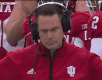 A Man Wearing A Headset With The Letter I On His Jacket GIF