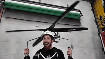 A Man Wearing A Helix Helmet Holds A Propeller In His Hands GIF