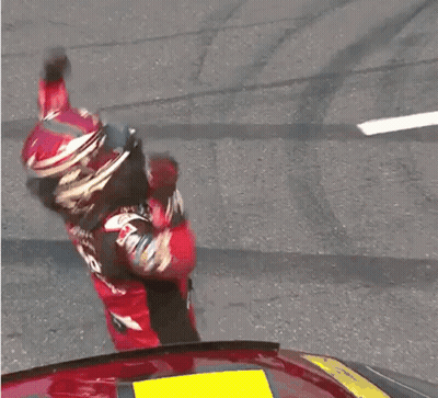 A Man Wearing A Helmet And A Jersey With The Number 5 On It Is Raising His Hands In The Air GIF