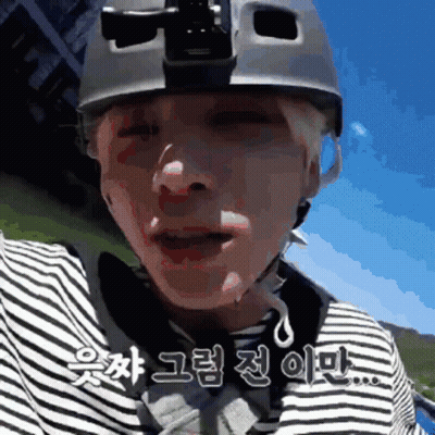 A Man Wearing A Helmet And A Striped Shirt Is Talking In Korean GIF