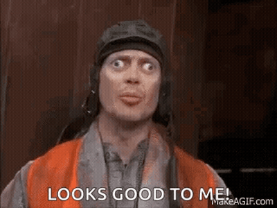 A Man Wearing A Helmet And An Orange Vest Is Making A Funny Face And Saying `` Looks Good To Me ! '' GIF