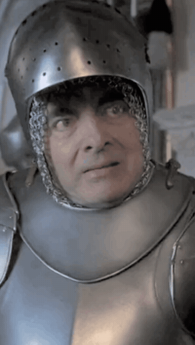 A Man Wearing A Helmet And Armor Looks At The Camera GIF