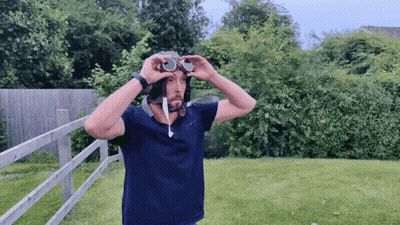 A Man Wearing A Helmet And Goggles In A Yard GIF