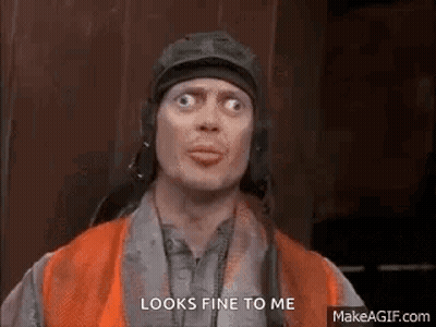 A Man Wearing A Helmet And Goggles Is Making A Funny Face . GIF