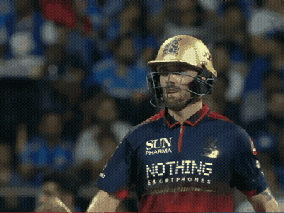 A Man Wearing A Helmet And Holding A Bat That Says Ton On It GIF