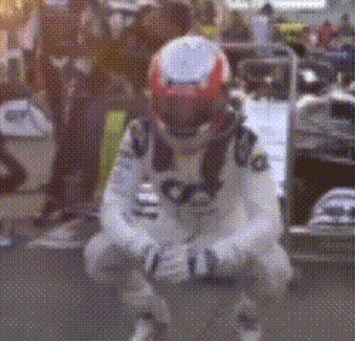 A Man Wearing A Helmet Is Kneeling Down On The Ground . GIF