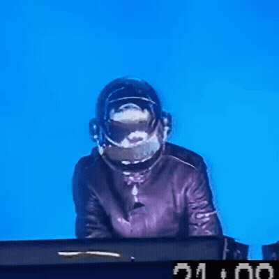 A Man Wearing A Helmet Is Playing A Keyboard With A Clock That Says 21:00 On It GIF