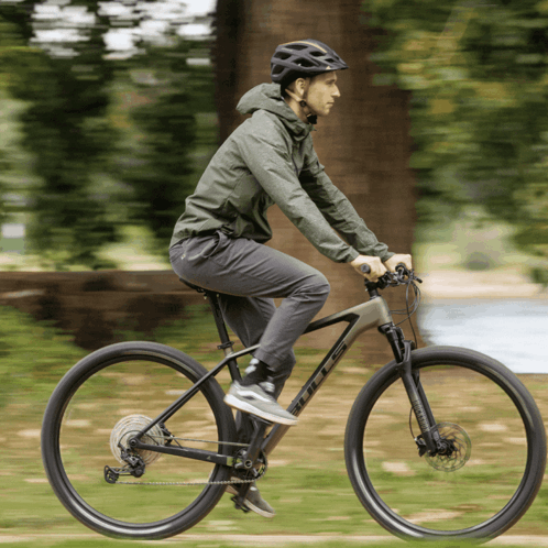 A Man Wearing A Helmet Is Riding A Bike That Says Scott On The Front GIF