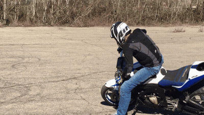 A Man Wearing A Helmet Is Riding A Motorcycle GIF