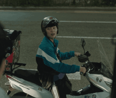 A Man Wearing A Helmet Is Riding A Motorcycle With A Box On The Back Of It GIF