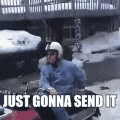 a man wearing a helmet is riding a snowmobile with the words just gonna send it below him .