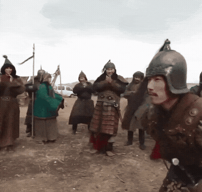 A Man Wearing A Helmet Is Surrounded By Other Men In Armor GIF