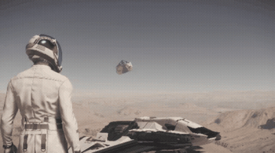 A Man Wearing A Helmet Stands In Front Of A Space Ship In The Desert GIF