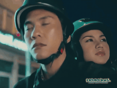 A Man Wearing A Helmet Stands Next To A Woman Wearing A Hijab And The Words Istanbul Aku Datangi Are Visible GIF