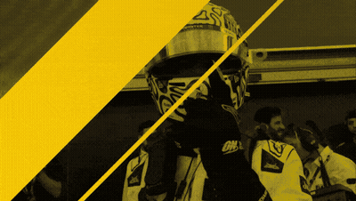A Man Wearing A Helmet That Says Monster Is Standing Next To Another Man GIF