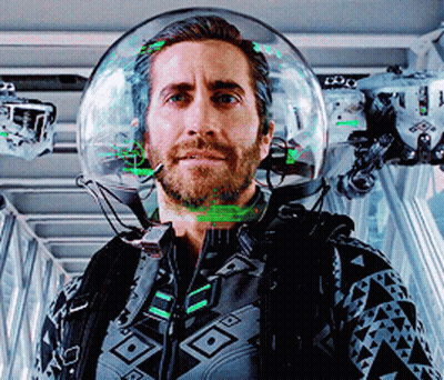 A Man Wearing A Helmet With A Green Light Coming Out Of It GIF