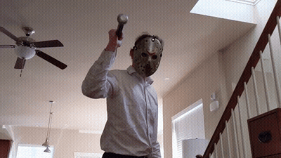A Man Wearing A Hockey Mask Holds A Microphone GIF