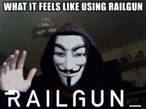 A Man Wearing A Hooded Jacket And A Anonymous Mask Is Making A Funny Meme . GIF