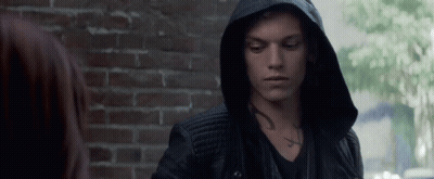 A Man Wearing A Hooded Jacket Has A Tattoo On His Chest GIF