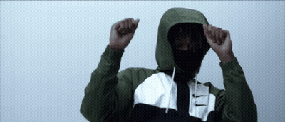 A Man Wearing A Hooded Jacket With A Nike Logo On The Front GIF