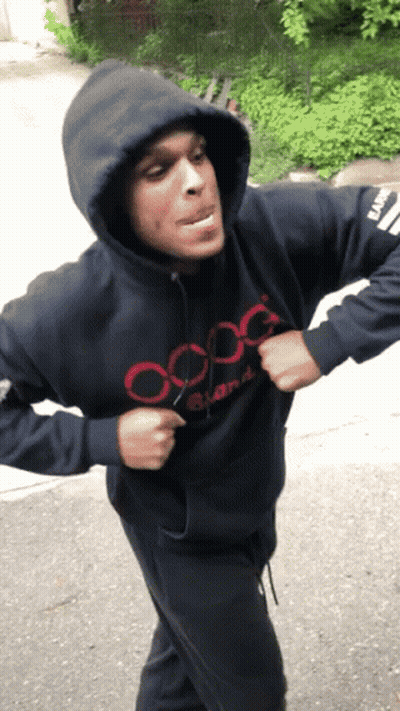 A Man Wearing A Hooded Sweatshirt That Says Oxg GIF