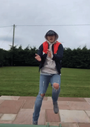 A Man Wearing A Hoodie And A Hat With The Word Coca Cola On It GIF