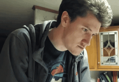 A Man Wearing A Hoodie And A T-Shirt With The Letter M On The Sleeve GIF