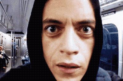 A Man Wearing A Hoodie Is Taking A Selfie On A Train GIF