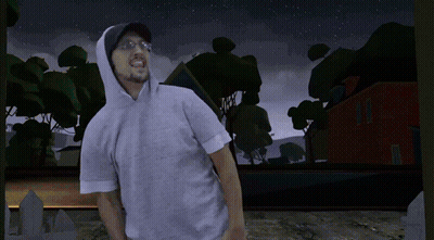 A Man Wearing A Hoodie Stands In Front Of A Cemetery At Night GIF