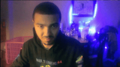 A Man Wearing A Hoodie That Says Nintendo 64 Looks At The Camera GIF