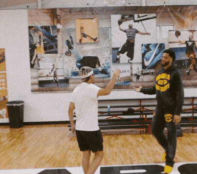 A Man Wearing A Hoodie That Says Warriors On It Talks To Another Man GIF