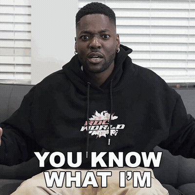 A Man Wearing A Hoodie That Says " You Know What I 'M " Is Sitting On A Couch GIF