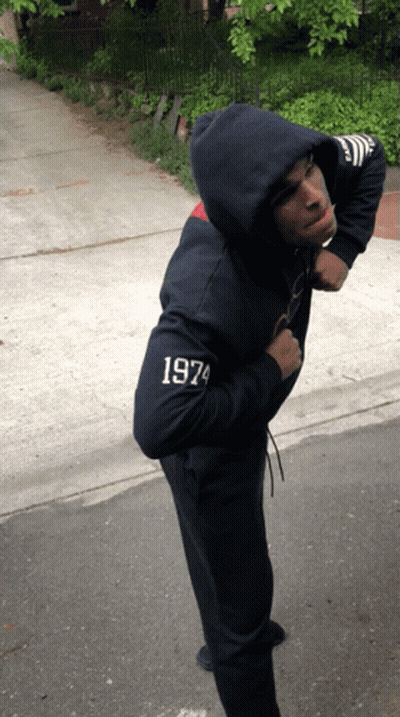 A Man Wearing A Hoodie With 1974 On The Sleeve GIF