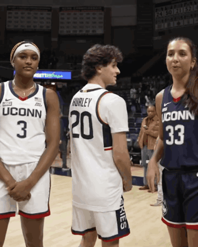 A Man Wearing A Hurley Jersey Stands Next To Two Women Wearing Uconn Jerseys GIF