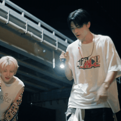 A Man Wearing A Jack T-Shirt Holds A Flashlight In His Hand GIF